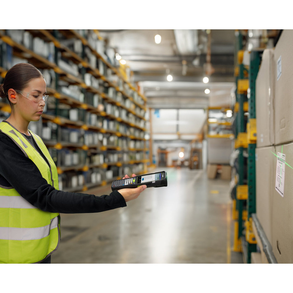 Zebra MC3400 rugged keypad mobile computer, straight shooter, 29-key numeric keypad (MC3401-0S1P62SS-A6) – in use in a warehouse