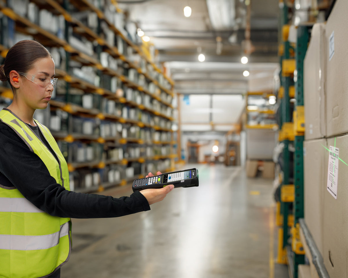 Zebra MC3400 rugged keypad mobile computer, straight shooter, 29-key numeric keypad (MC3401-0S1J52SS-A6) – in use in a warehouse
