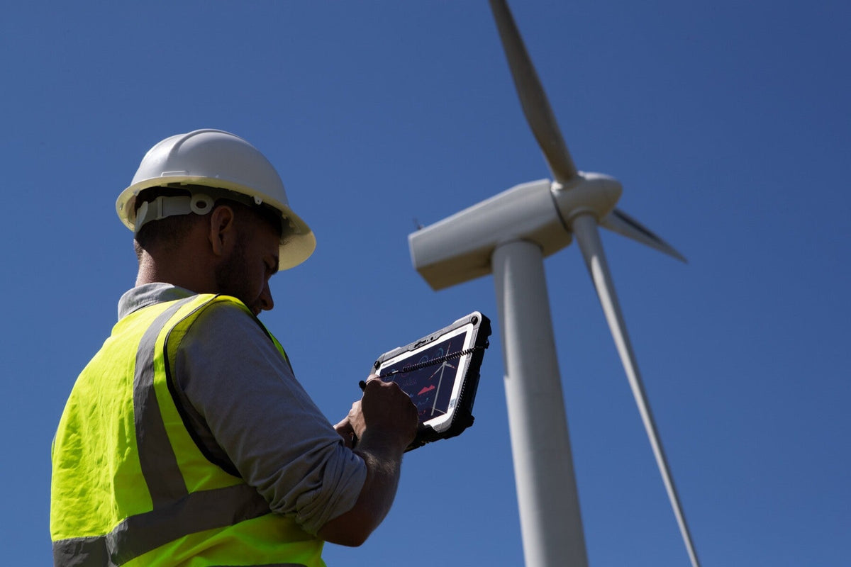Wind farm engineer using the Panasonic TOUGHBOOK G2 mk3 (Wi-Fi, EU plug) rugged tablet outdoors in direct sunlight