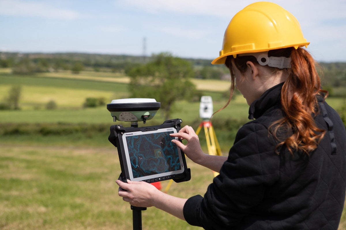 Surveyor using the Panasonic TOUGHBOOK G2 mk3 (5G, UK plug) on a GNSS pole for field mapping and GIS data capture
